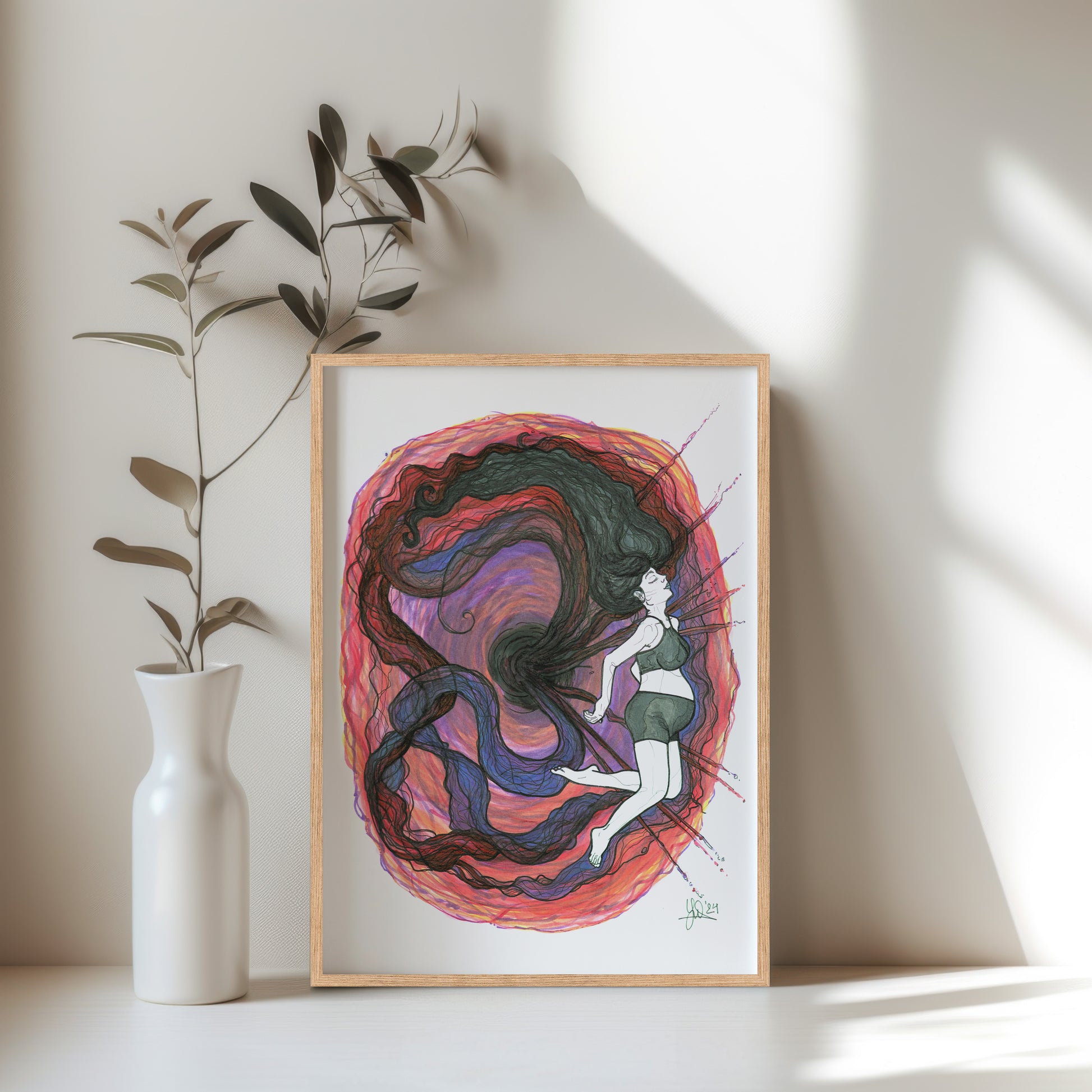 Framed colorful artwork of a woman with flowing hair on a white wall. A piece on becoming a mother or parent.