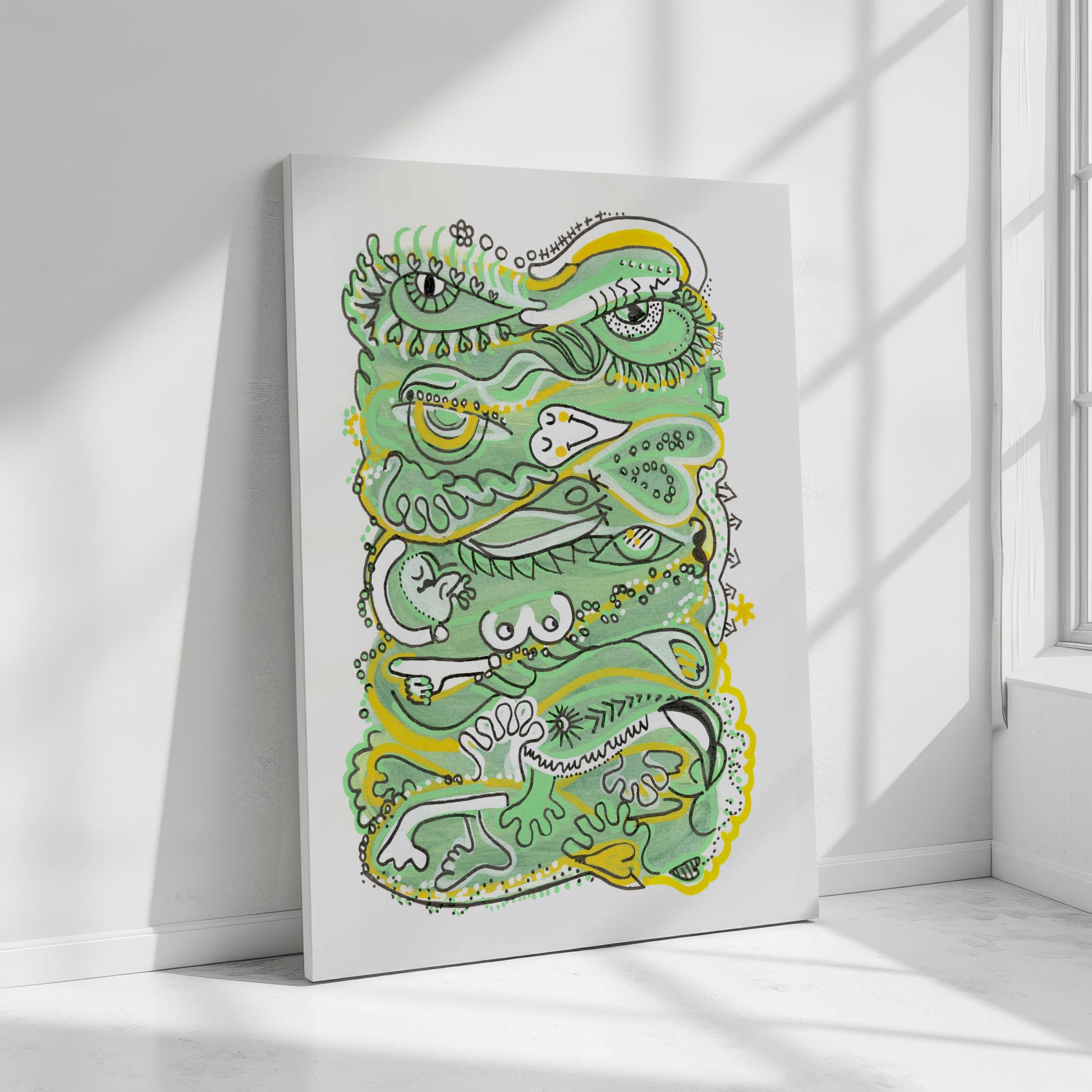 Canvas print with a green and yellow abstract design on a white wall. A piece on Humanity.