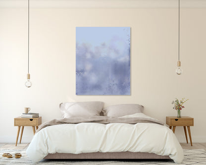 A modern bedroom featuring a square abstract art print with soft blue and purple brushstrokes hanging on the wall above a neatly made bed with white linens.